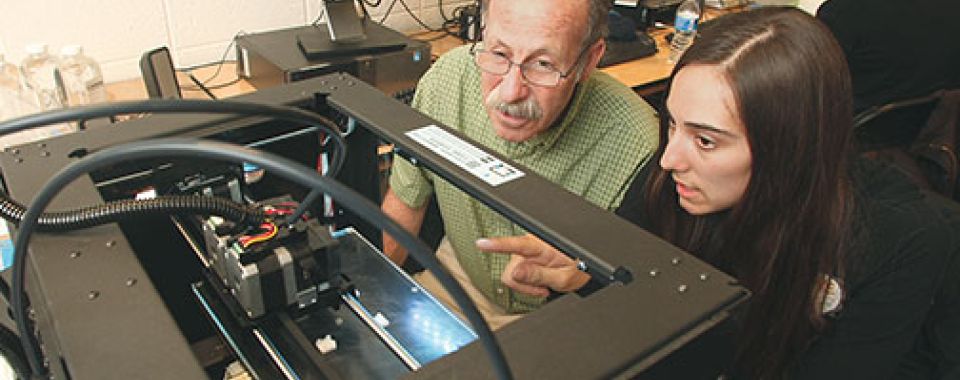 Professor Michael Littman and Cara de Freitas Bart ’15 review the results of a 3-D printing test.