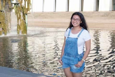 Adelle Ingrid Dimitui smiling in front of fountain