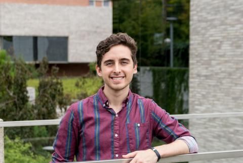 Christopher Galea smiling outside with arm on railing