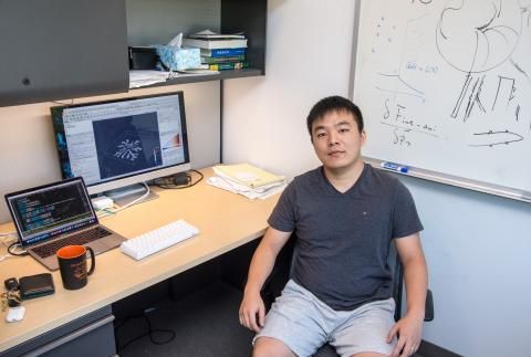 Yan Xia sitting at desk