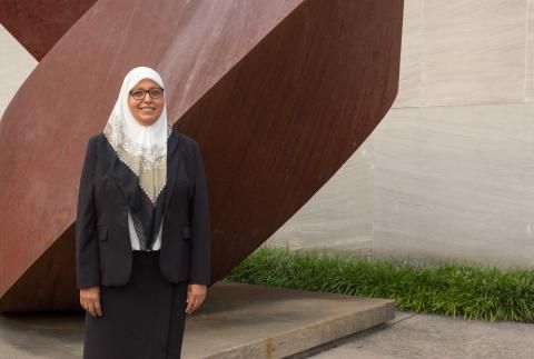 Lamyaa El-Gabry smiling in front of sculpture