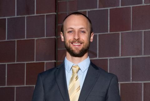 Will Coogan smiling in suit and tie