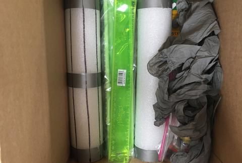 Lab materials in box wrapped in plastic and styrofoam