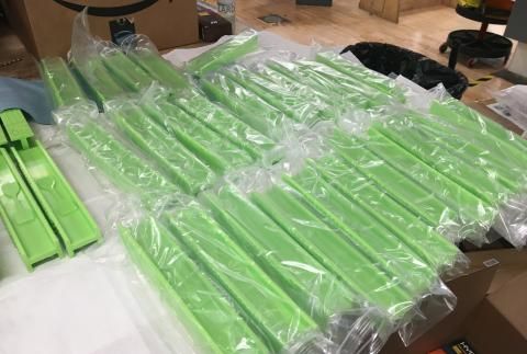 Table covered with green instruments wrapped in plastic
