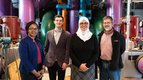 Princeton senior Harry Shapiro (second from left) developed a mathematical model to help reduce costs and carbon emissions from campus energy use. He worked with (from left) Ijeoma Nwagwu, assistant director of academic engagement and Campus as Lab initiatives at the Office of Sustainability; his thesis adviser Lamyaa El-Gabry, a lecturer in the Department of Mechanical and Aerospace Engineering; and Ted Borer, director of the campus energy plant. Photo by Tori Repp/Fotobuddy